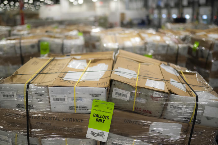 Pallets filled with Washington and Oregon mail-in ballots fill an unloading area at a U.S. Postal Service processing and distribution center on Oct. 14, 2020, in Portland, Ore.