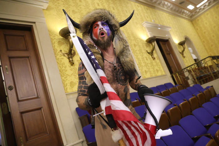 Jacob Chansley, photographed during the Jan. 6 U.S. Capitol insurrection, screams "Freedom" inside the Senate chamber following the breach of a mob during a joint session of Congress.