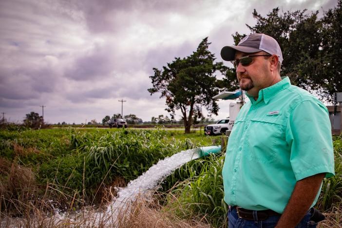 Christian Richard stands next to a groundwater well on his southwestern Louisiana farm. A centuries-old law allows landowners in the state to use as much water as they want for free.