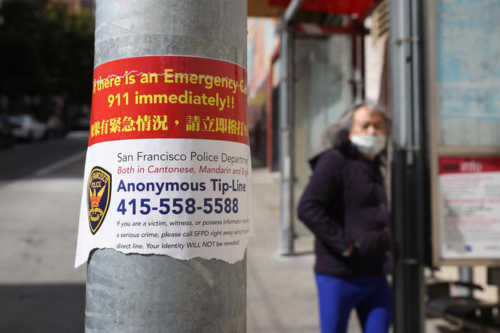 A sign posted in San Francisco's Chinatown neighborhood on March 8 encourages people to call a police tip line if they witness a crime.