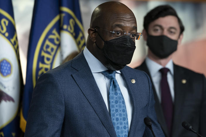 Sen. Raphael Warnock, D-Ga., left, accompanied by Sen. Jon Ossoff, D-Ga., speaks during a news conference, before the vote on the Democrat's $1.9 trillion COVID-19 relief bill on March 10, 2021.