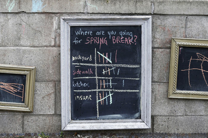 For lighter moments during the coronavirus pandemic, passersby had an opportunity to vote for their stay at home spring break moments on the retaining wall of a home in St. Paul, Minn.