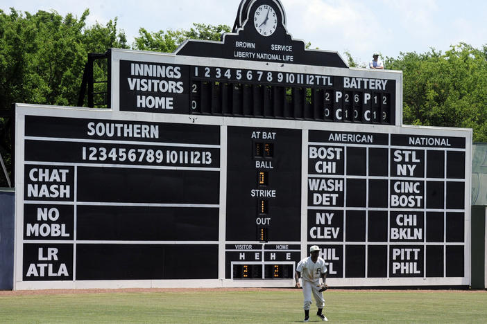 Birmingham Barons outfielder Luis Basabe moves toward a ball in front of the vintage scoreboard in 2019 at Rickwood Field, America's oldest baseball park, in Birmingham, Ala.