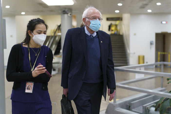 Sen. Bernie Sanders returns to his office on March 5, 2021, while the Senate works on the Democrats' $1.9 trillion COVID-19 relief bill. Sanders calls the recently passed package "the most consequential" for working families in decades.