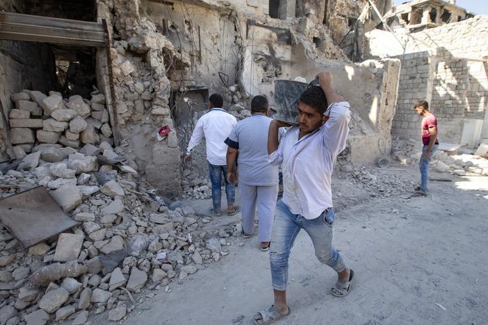 Volunteers clear the Old Market district of debris in Aleppo, Syria, in 2019. Years of fighting have left many sections of Aleppo destroyed.