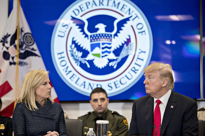Then-President Donald Trump and the Homeland Security secretary at the time, Kirstjen Nielsen, speak during a Customs and Border Protection roundtable in Virginia in 2018. The Biden administration rescinded an agreement from that time between the Homeland Security and Health and Human Services departments that it says hampered efforts to find safe homes for unaccompanied minors.