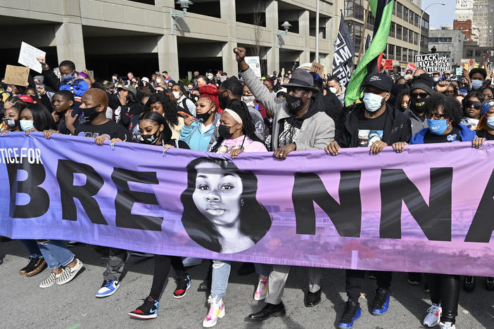 Tamika Palmer (center), the mother of Breonna Taylor, leads a march through the streets of downtown Louisville on the anniversary of Taylor's death on Saturday.