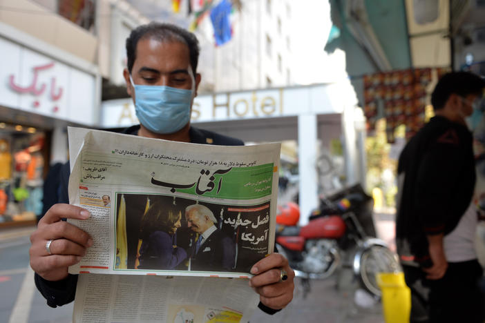A man reads the news about the U.S. elections on Nov. 9 in Tehran. Many Iranians are hopeful that President Biden will lifts sanctions imposed on Iran by his predecessor.