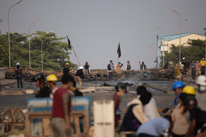 Protesters in Yangon, Myanmar, stand near makeshift barricades during demonstrations against the country's military coup.