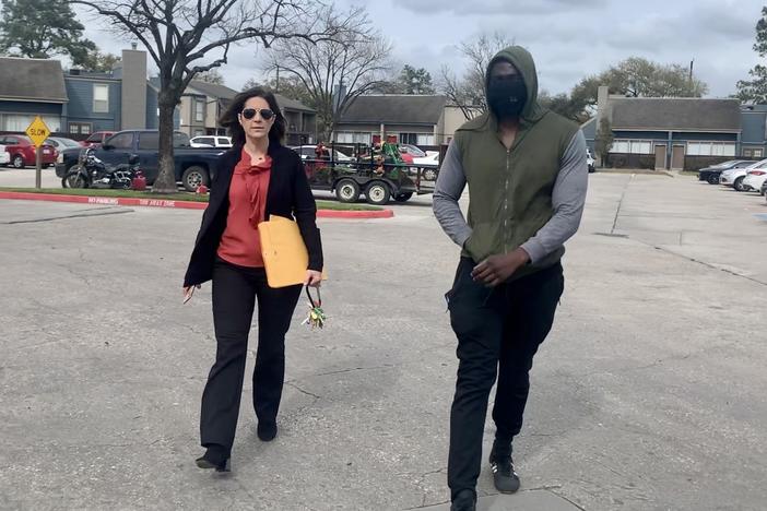 Landlord Stephanie Graves walks to the main office at one of her properties in Houston with a resident. She's going door to door offering to help residents apply for rental assistance money approved by Congress that's just starting to flow to landlords and tenants.