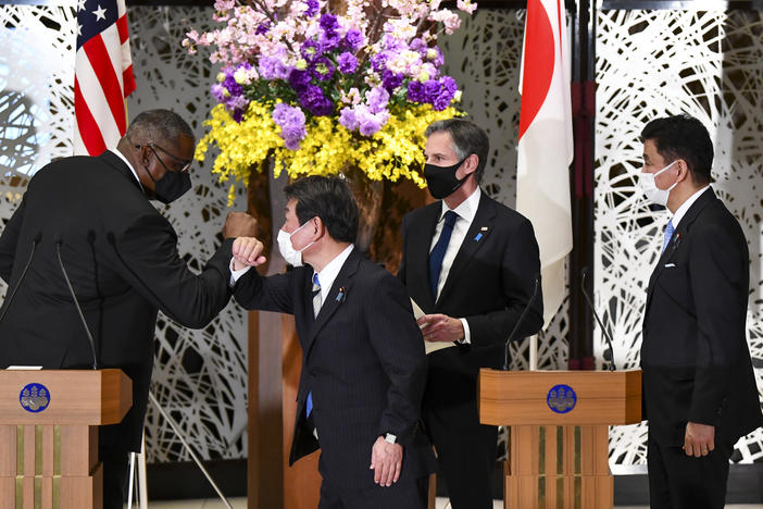 U.S. Defense Secretary Lloyd Austin, left, elbow bumps with Japan's Foreign Minister Toshimitsu Motegi, center, as Secretary of State Antony Blinken and Japanese Defense Minister Nobuo Kishi watch after a joint news conference in Tokyo Tuesday.