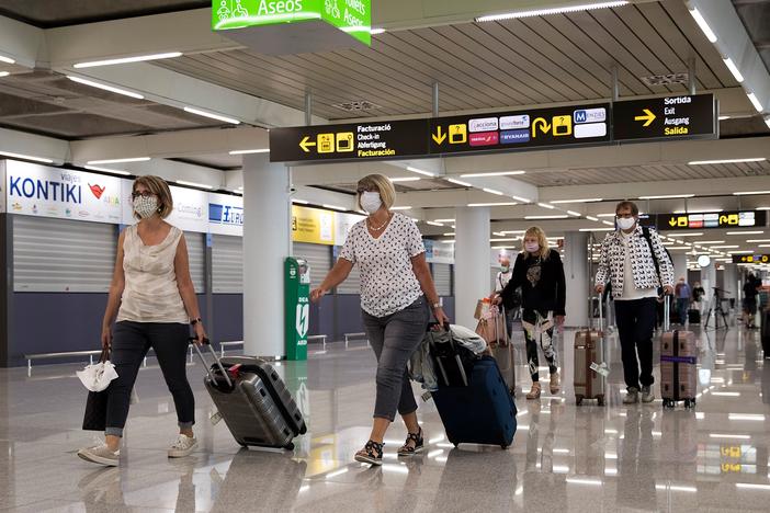 Tourists arrive at Palma de Mallorca, Spain, last summer. The EU's executive arm has proposed a certificate to ease travel across its member states.