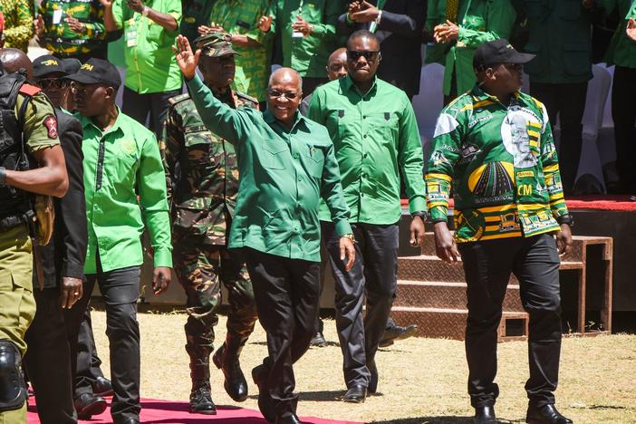 Tanzanian President John Magufuli (center) arrives to give a speech at a stadium in Dodoma, Tanzania, in August. Magufuli's death was announced Wednesday. He was 61.