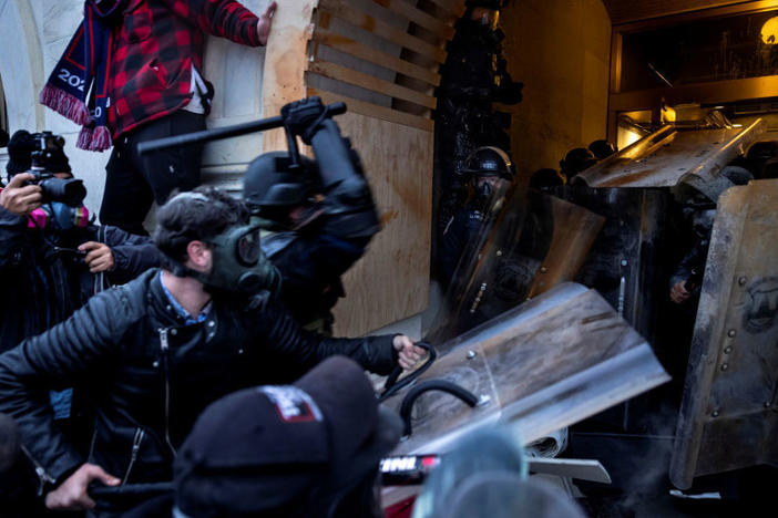 Rioters clash with police and security forces as people try to storm the U.S. Capitol on Jan. 6. The FBI is undertaking an extensive investigation to identify and charge hundreds of individuals.