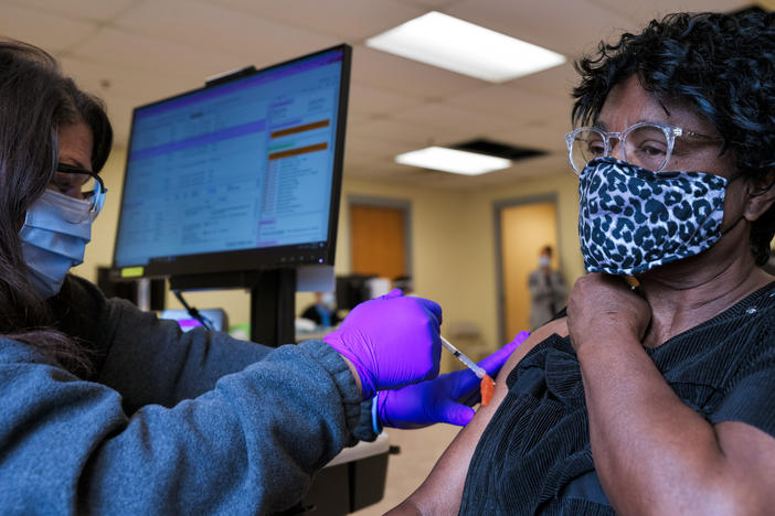 A woman receives the Moderna COVID-19 vaccine at the Bates Memorial Baptist Church in Louisville, Ky., on Feb. 12. Yet in many states, there are racial disparities in who has received the shot.