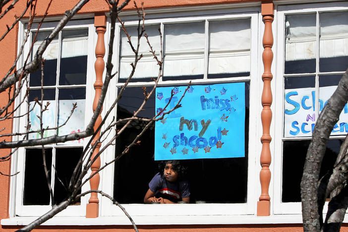 Jeevan Guha, 6, offers a view of pandemic-era schooling with this homemade sign in San Francisco. The sign reads, "I miss my school."