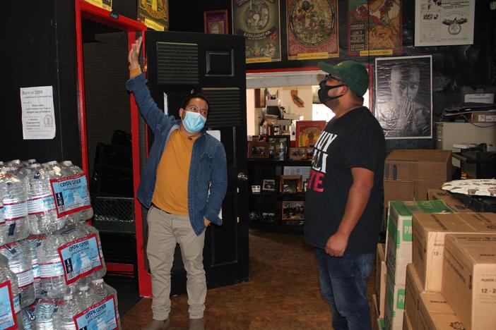 Radio B'alam founders Henry Sales and Crecensio Ramirez check out Radio B'alam's sound booth at Homies Empowerment the day before the shows first broadcast, December 2020.