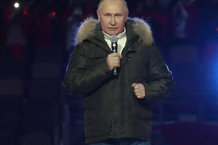 Russian President Vladimir Putin speaks Thursday before a concert marking the seventh anniversary of the annexation of Crimea from Ukraine. The banner behind him reads, "Russia-Crimea-Sevastopol."
