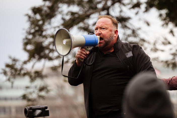 Alex Jones addresses a pro-Trump crowd on Jan. 6, the day of the U.S. Capitol riot. Jones is widely known for his support of baseless and often bigoted conspiracy theories, and he has been banned from many tech platforms, though not Amazon.