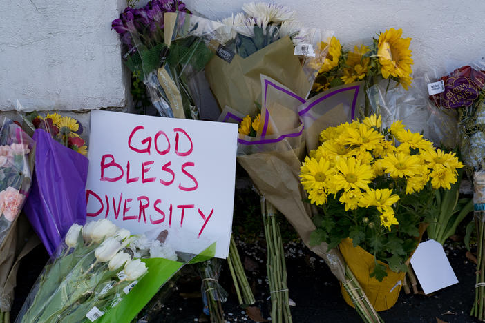 Flowers and signs adorn Gold Spa in Atlanta during a demonstration on Thursday opposing violence against women and Asians following this week's deadly shootings in the area.