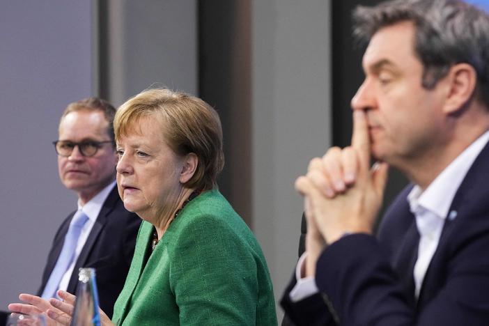 German Chancellor Angela Merkel, with Bavaria's State Premier Markus Soeder (right) and Berlin's Mayor Michael Mueller, participate in a news conference following talks via videoconference with Germany's state premiers on the extension of the current COVID-19 lockdown in Germany.