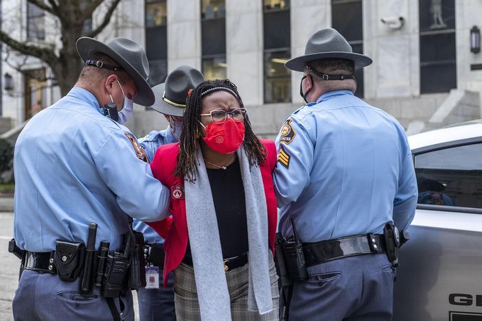 State Rep. Park Cannon is placed into the back of a Georgia State Capitol patrol car after being arrested at the state Capitol. Cannon was arrested after she attempted to knock on the door of Gov. Brian Kemp's office during his remarks after signing into law a sweeping Republican-sponsored overhaul of state elections.