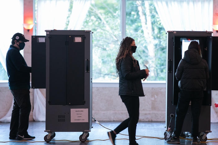 Voters in Atlanta casting their ballots on voting equipment made by Dominion Voting Systems. After losing the election, former President Trump and his allies spread conspiracy theories about the company, which has responded with defamation suits to combat the disinformation.