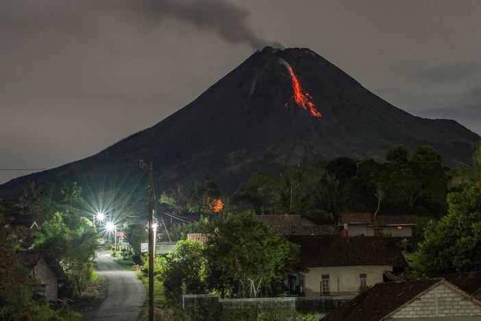Lava flows down from the crater of Mount Merapi, Indonesia's most active volcano, as seen from Tunggul Arum in the city of Turi near Yogyakarta early Saturday.