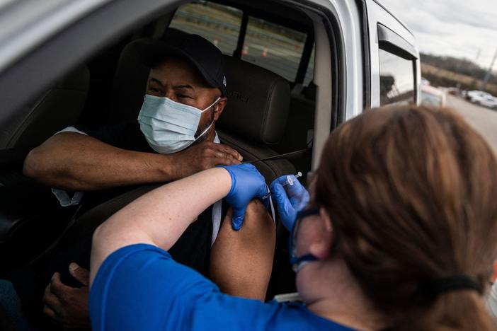 A nurse administers a shot at a COVID-19 mass vaccination site at Martinsville speedway in Ridgeway, Va., on March 12. Ashish Jha, a public health policy researcher, noted Sunday that "despite phenomenal vaccination rates, variants pulled ahead this week."
