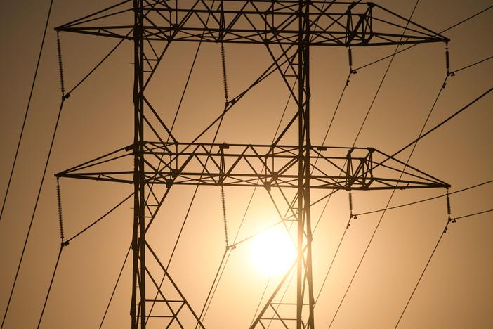 Electrical power line towers are seen in Los Angeles in August. Overdue power bills have mushroomed during the pandemic as job losses mounted and power consumption soared.