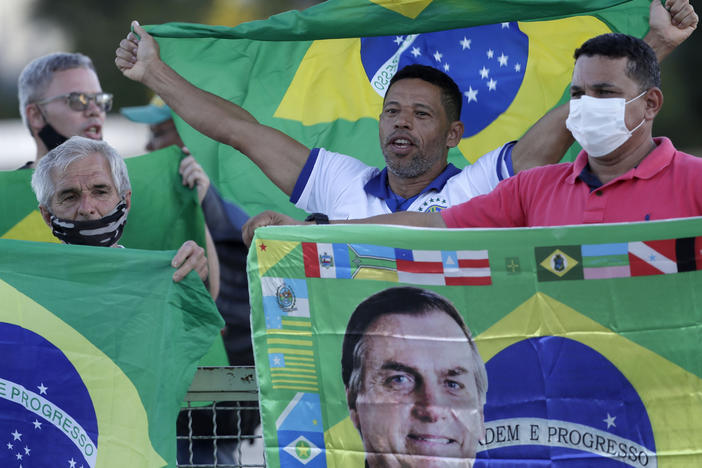 Demonstrators show support for Brazilian President Jair Bolsonaro in front of the presidential palace Monday in Brasilia. Bolsonaro reshuffled his Cabinet amid turmoil in his administration and dropping approval ratings over the coronavirus pandemic.