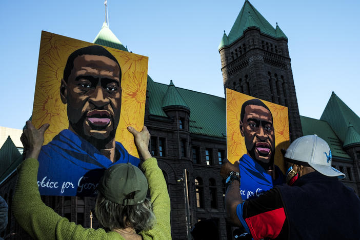 People gather during a demonstration outside the Hennepin County Government Center in Minneapolis on Monday as opening statements were given in the trial of former Minneapolis police officer Derek Chauvin, charged in the killing of George Floyd.
