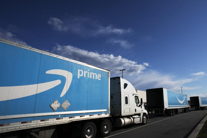 Amazon tractor-trailers line up outside an Amazon Fulfillment Center on Staten Island in New York City in April 2020. The pandemic has been good for the company's bottom line.