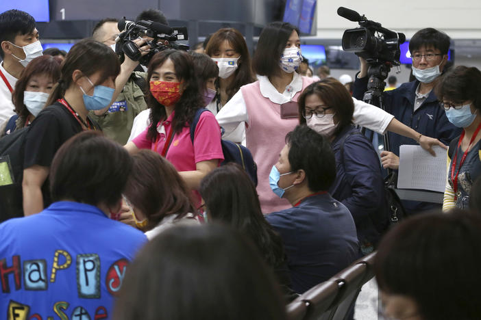 A group of tourists prepares to take COVID-19 tests at Taoyuan International Airport on Thursday, the first day of the new Palau-Taiwan Travel Corridor.