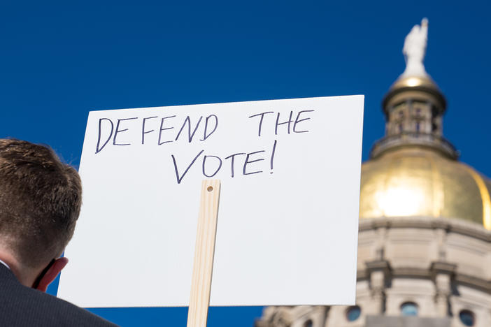 Demonstrators protest House Bill 531 last month in Atlanta. The legislation signed into law has drawn criticism from voting rights activists and businesses, who say it limits access to the polls and disproportionately harms voters of color.