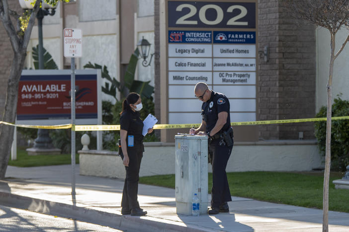 Authorities are investigating a mass shooting that killed four people and injured one at a business complex in Orange, Calif.