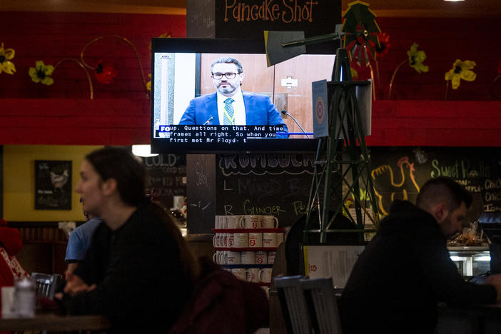 The trial of former officer Derek Chauvin has completed its fifth day of witness testimony. Here, a Minneapolis restaurant shows the trial on TV in its dining room Thursday.