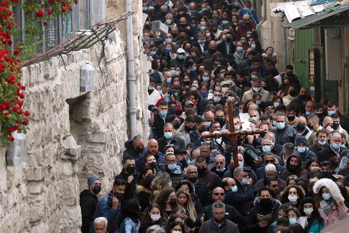 Christian worshippers carry a wooden cross on Friday along the path where tradition says Jesus took his final steps before his crucifixion in Jerusalem's Old City.