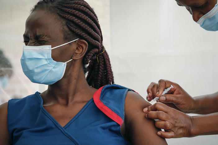 A front-line worker in Kenya receives a shot of the AstraZeneca COVID-19 vaccine. African Family Holistic Health Organization in Portland, Ore., hopes that the work it does in the U.S. will help curb vaccine misinformation back in Africa.