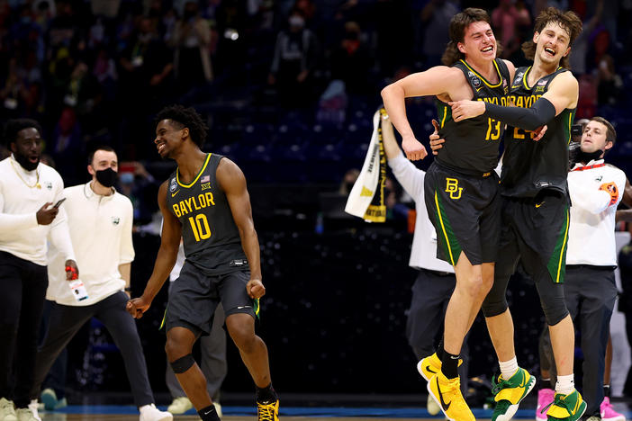 Baylor players (from left) Adam Flagler, Jackson Moffatt and Matthew Mayer celebrate after defeating the Gonzaga Bulldogs in the National Championship game of the 2021 NCAA Men's Basketball Tournament at Lucas Oil Stadium.