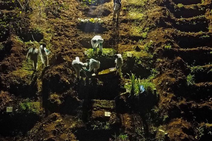 A coffin is buried at the Vila Formosa cemetery in Sao Paulo, Brazil, late last month. Brazil has been experiencing record numbers of coronavirus infections and COVID-19 deaths in recent weeks.