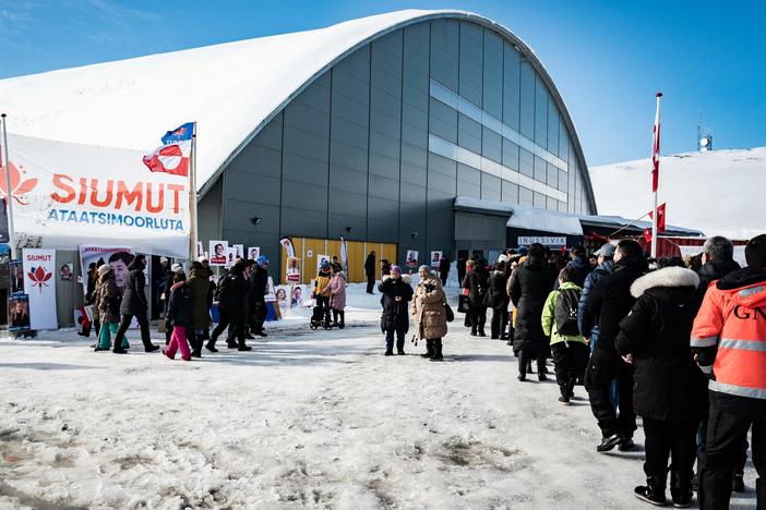 Voters stand in line to cast ballots Tuesday for Greenland's parliamentary elections at a polling station in the capital.