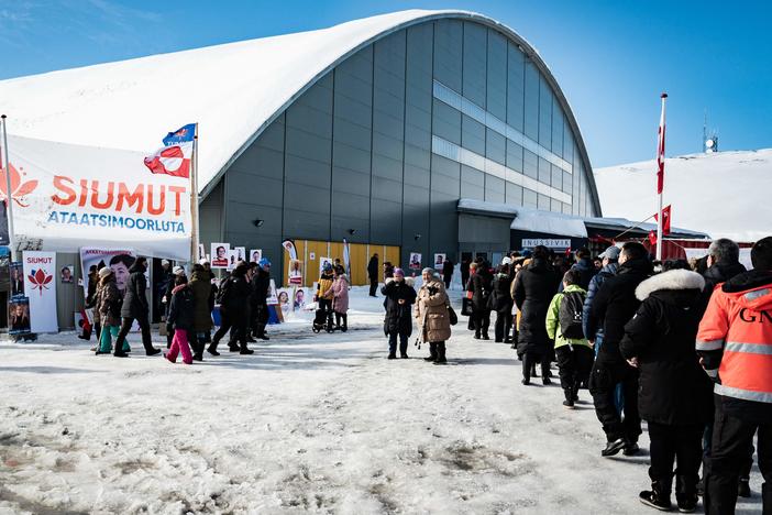 Voters stand in line to cast ballots Tuesday for Greenland's parliamentary elections at a polling station in the capital.