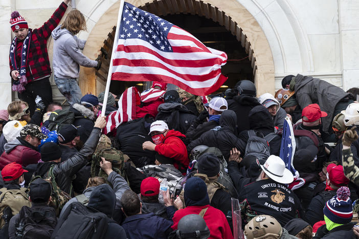 Rioters clash with police trying to enter Capitol building through the front doors. Rioters broke windows and breached the Capitol building in an attempt to overthrow the results of the 2020 election.