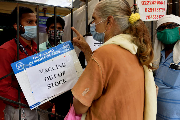 A public notice hangs outside a vaccination center notifying of vaccine shortages in Mahim, in Mumbai, India, on Thursday.