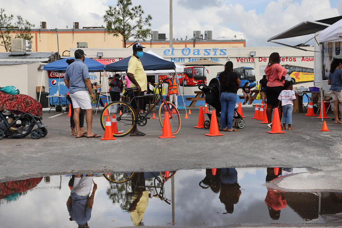 People line up to receive a rapid COVID-19 test on Feb. 17, 2021 in Immokalee, Fla. Immokalee, which has a poverty rate of around 40% and whose population is made up primarily of agricultural workers, has joined with the Coalition of Immokalee Workers and Partners in Health to test, educate and vaccinate the community during the COVID-19 outbreak.