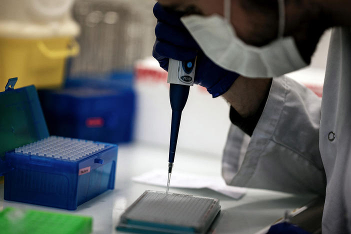 A scientist works on COVID-19 samples to find variations of the virus at the Croix-Rousse Hospital laboratory in Lyon, France, in January.