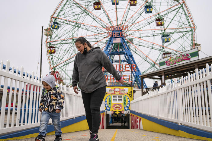 Visitors leave the Wonder Wheel ride after the re-opening of Coney Island's amusement parks on Friday.