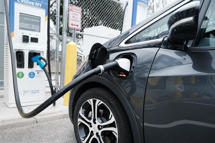 A driver uses a fast-charging station for electric vehicles at New York's John F. Kennedy Airport on April 2. As part of President Biden's $2 trillion infrastructure plan, $174 billion would go to supporting the production of electric vehicles in the U.S.