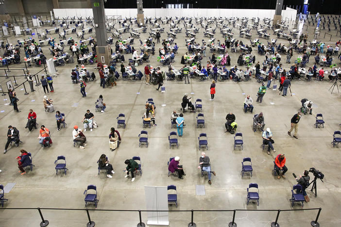 A mass vaccination site at the Lumen Field Event Center in Seattle had plenty of takers for the COVID-19 vaccine when it opened in mid-March. Though some relatively rare cases of coronavirus infection have been documented despite vaccination, "I don't see anything that changes our concept of the vaccine and its efficacy," says Dr. Anthony Fauci of the National Institutes of Health.